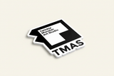 TMAS logo magnet - angled view